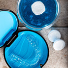 Clear mouthguard in a blue case with Puradent tablets