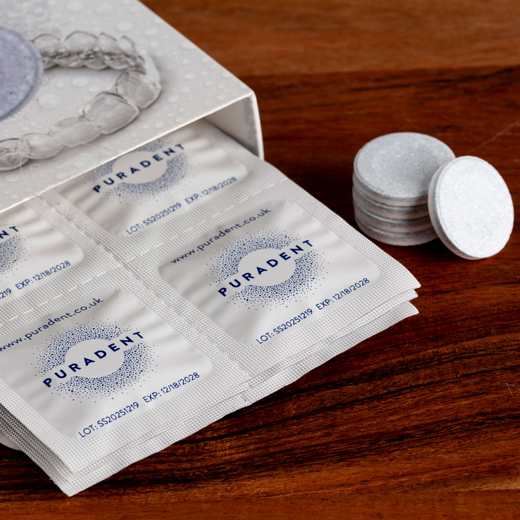 Puradent dental tablets in packaging on a wooden surface